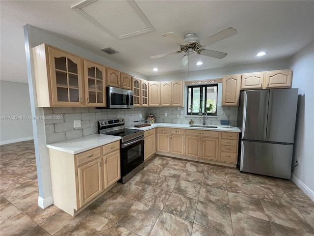 kitchen featuring stainless steel appliances, tasteful backsplash, sink, and light brown cabinets