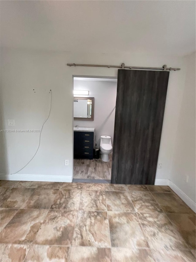 spare room with a barn door