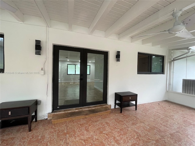 view of exterior entry with central air condition unit, a patio area, ceiling fan, and french doors