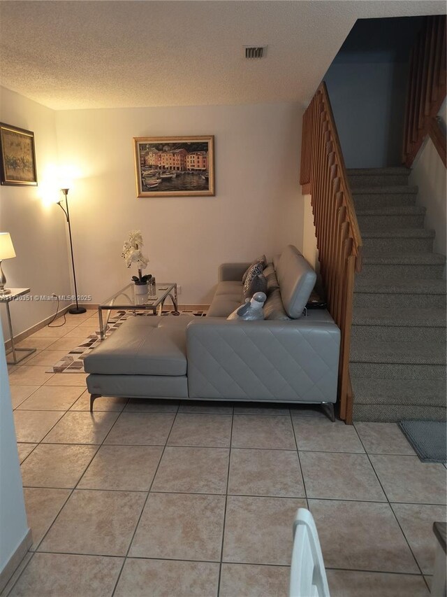 tiled living room with a textured ceiling