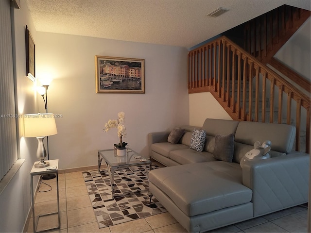 living room with light tile patterned floors and a textured ceiling