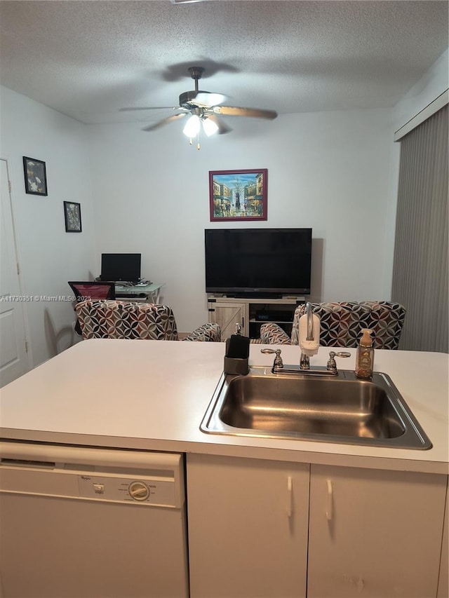 kitchen with ceiling fan, sink, a textured ceiling, and white dishwasher