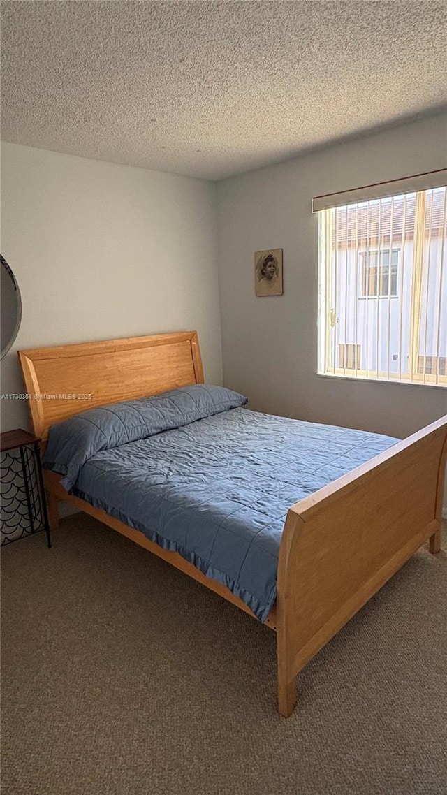 carpeted bedroom with a textured ceiling