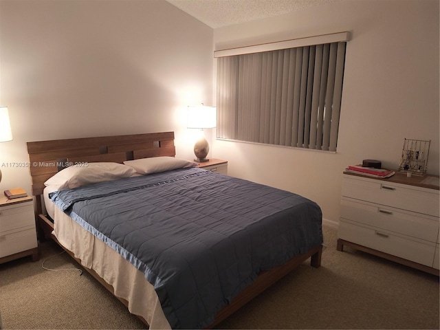 carpeted bedroom featuring a textured ceiling