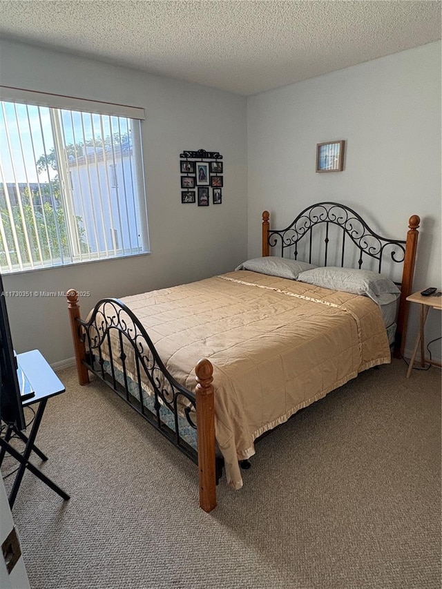 bedroom with carpet and a textured ceiling