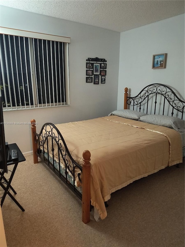 carpeted bedroom featuring a textured ceiling