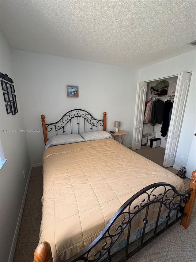 carpeted bedroom with a textured ceiling and a closet