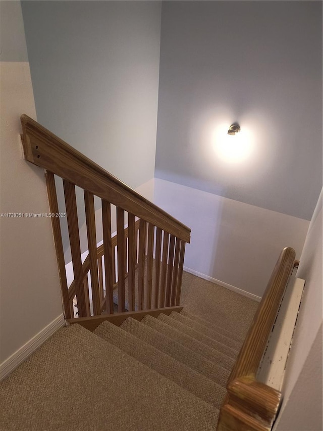 stairway featuring carpet and lofted ceiling