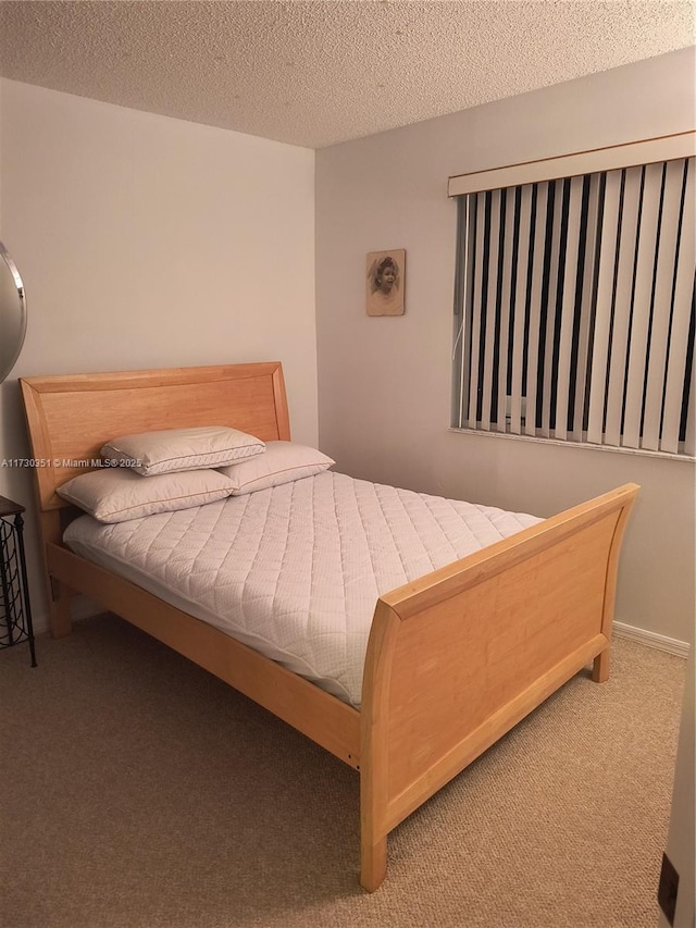 carpeted bedroom with a textured ceiling