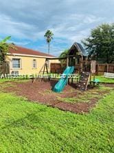 view of playground with a lawn