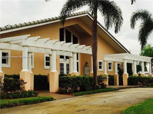 view of property exterior featuring a pergola