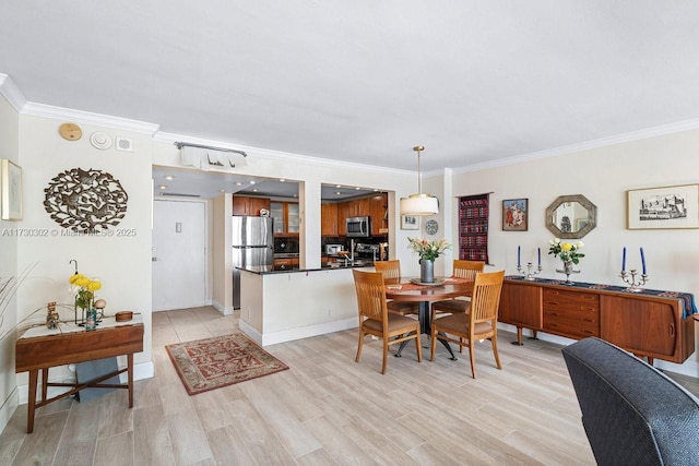 dining space featuring crown molding and light hardwood / wood-style floors