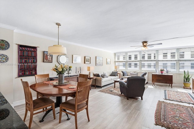 dining space featuring crown molding, ceiling fan, and light hardwood / wood-style floors