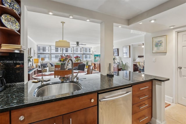 kitchen with dark stone countertops, sink, stainless steel dishwasher, and ceiling fan