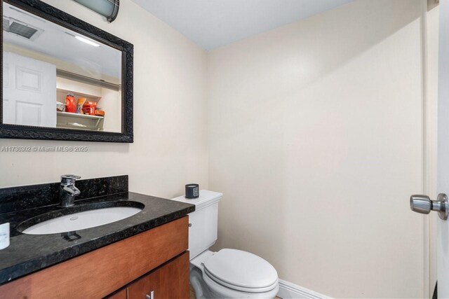 kitchen featuring dark stone countertops, stainless steel fridge, and light tile patterned flooring