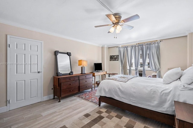 bedroom featuring ornamental molding, ceiling fan, and light wood-type flooring