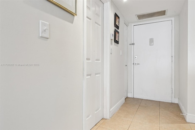 corridor featuring light tile patterned floors