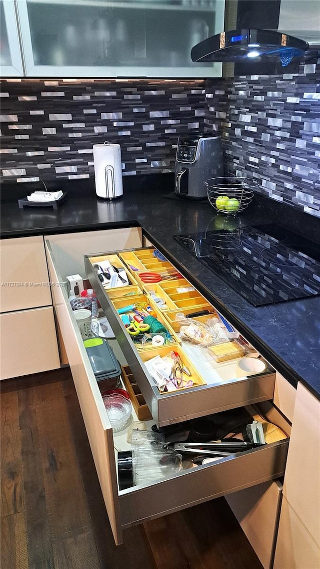 details featuring backsplash and hardwood / wood-style floors