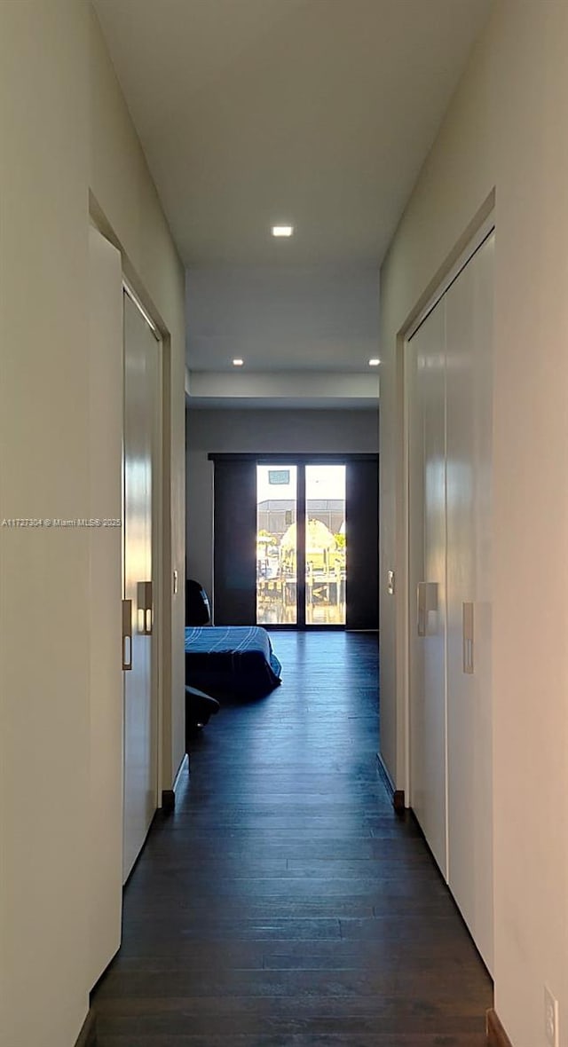 corridor featuring dark hardwood / wood-style floors