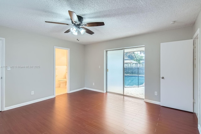 unfurnished room with ceiling fan, a textured ceiling, and dark hardwood / wood-style flooring