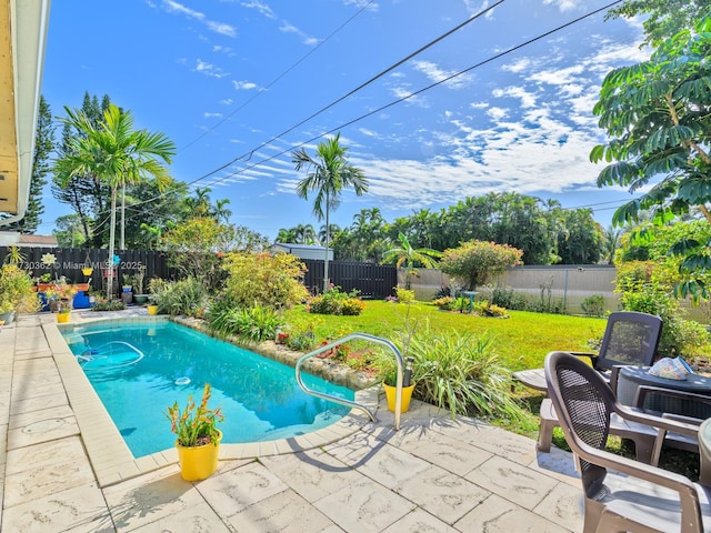 view of swimming pool featuring a lawn and a patio