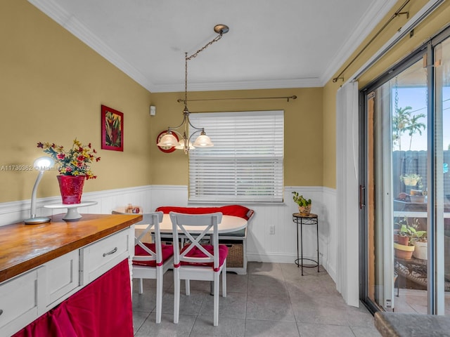 dining area featuring a notable chandelier, breakfast area, crown molding, and light tile patterned flooring