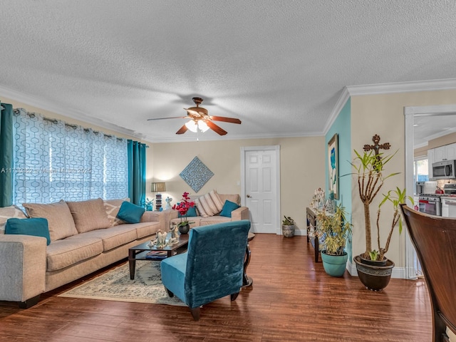 living room with hardwood / wood-style flooring, ceiling fan, crown molding, and a textured ceiling