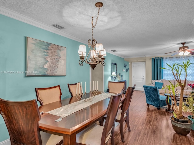 dining room with crown molding, wood-type flooring, a textured ceiling, and ceiling fan