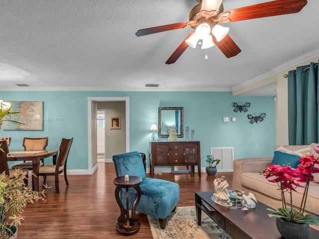 living room featuring ceiling fan, wood-type flooring, crown molding, and a textured ceiling