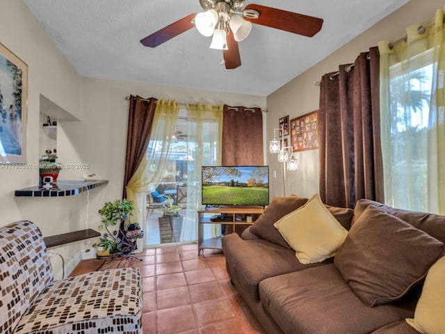 tiled living room featuring ceiling fan and a textured ceiling