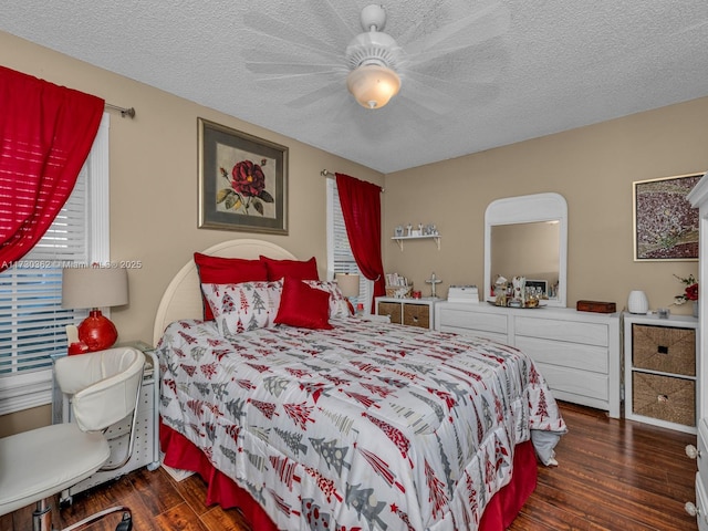 bedroom featuring ceiling fan, a textured ceiling, and dark hardwood / wood-style flooring