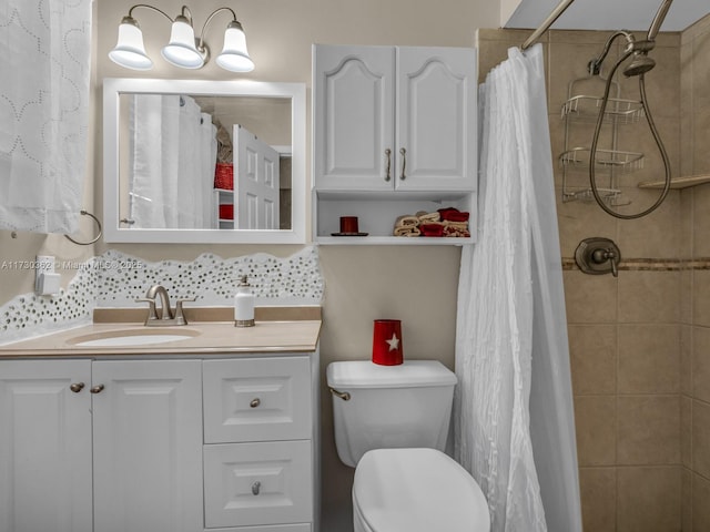 bathroom featuring vanity, toilet, walk in shower, and decorative backsplash