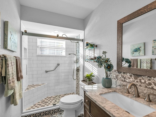 bathroom with vanity, toilet, and a shower with door