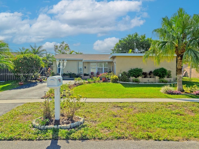 single story home featuring a front lawn