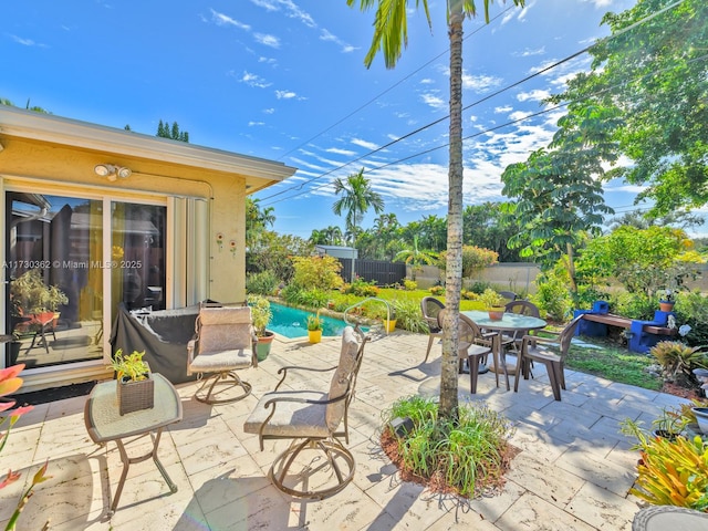 view of patio / terrace with a fenced in pool