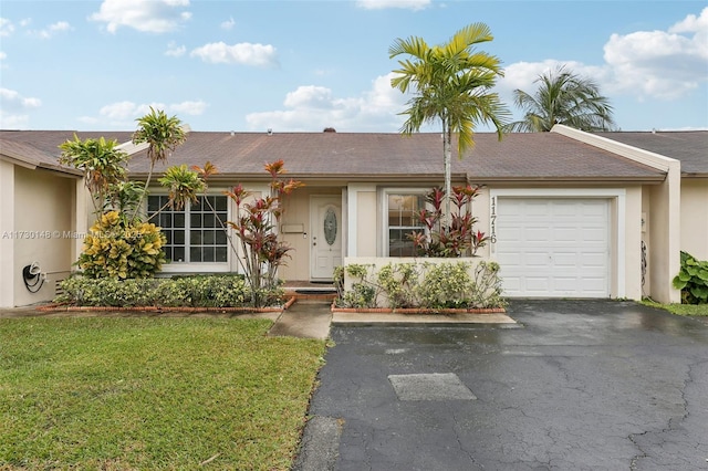 single story home with a garage and a front yard