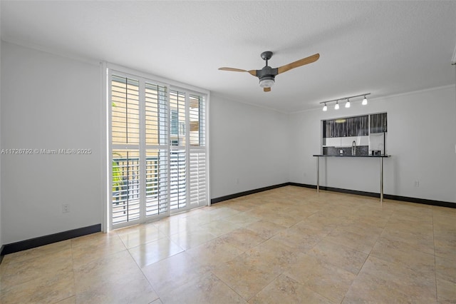 empty room with a textured ceiling and ceiling fan