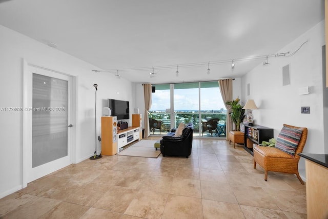 living room featuring track lighting and a wall of windows