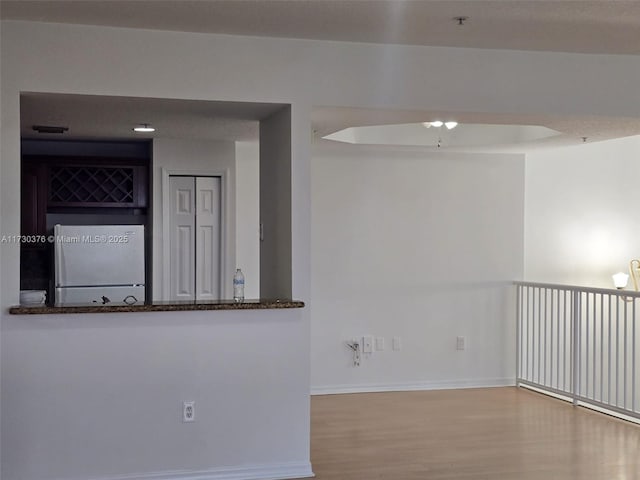 unfurnished room featuring a textured ceiling and light hardwood / wood-style flooring