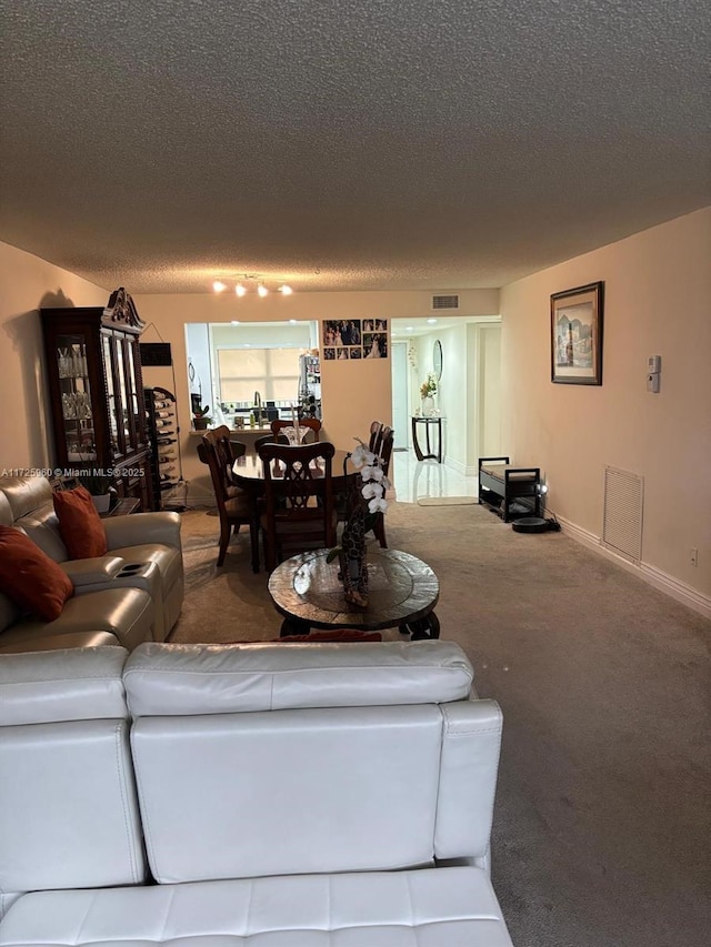 carpeted living room featuring a textured ceiling