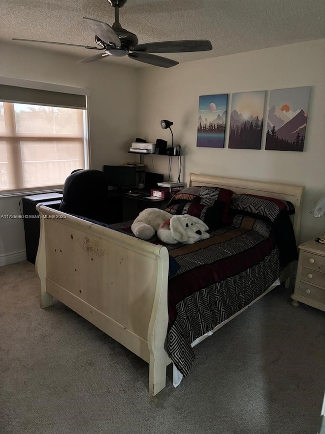 carpeted bedroom with a textured ceiling and ceiling fan