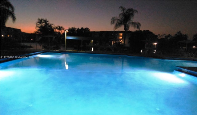 view of pool at dusk