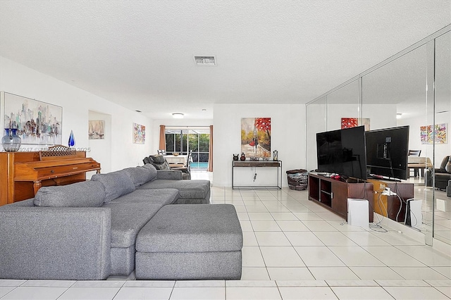 living room featuring light tile patterned floors and a textured ceiling