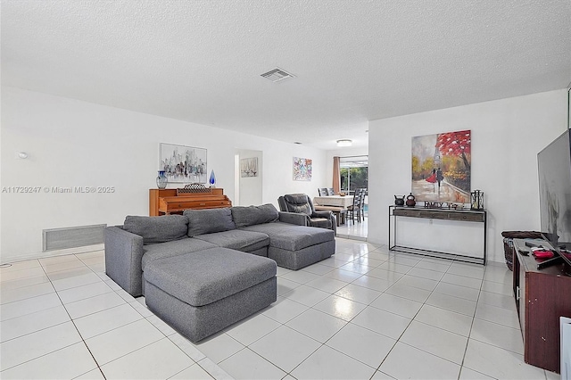 tiled living room with a textured ceiling