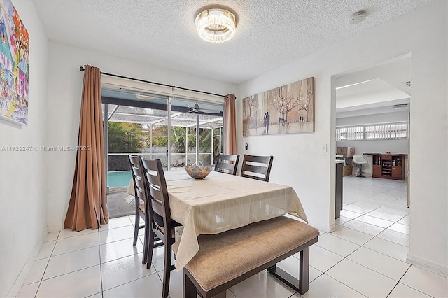 tiled dining space with a textured ceiling