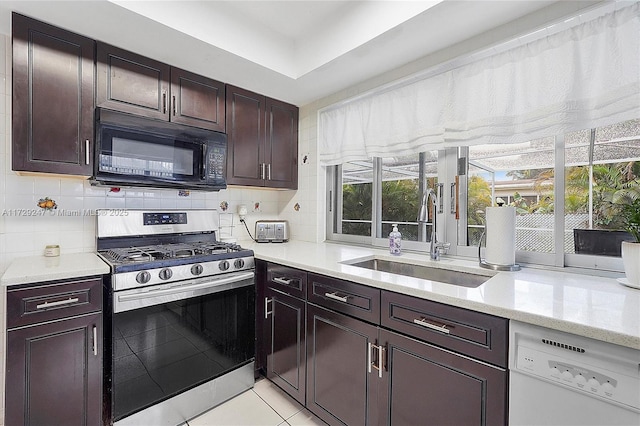 kitchen with dishwasher, sink, backsplash, light tile patterned flooring, and stainless steel gas range oven