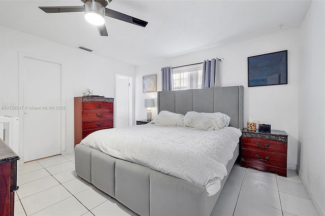 tiled bedroom featuring ceiling fan