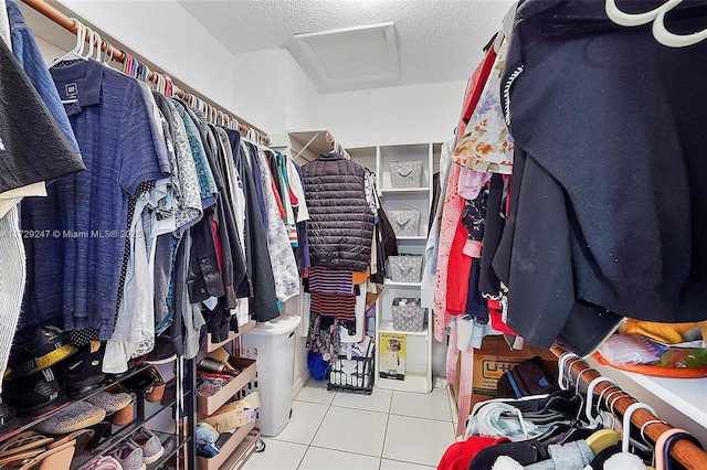 walk in closet with light tile patterned floors