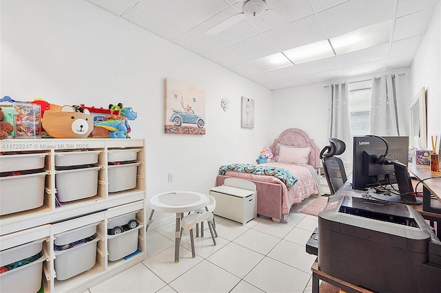 bedroom with a paneled ceiling and light tile patterned floors