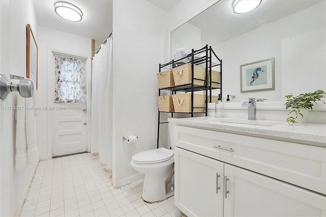 bathroom with vanity, toilet, and tile patterned floors